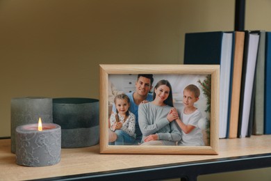 Photo of Framed family photo on wooden shelf indoors