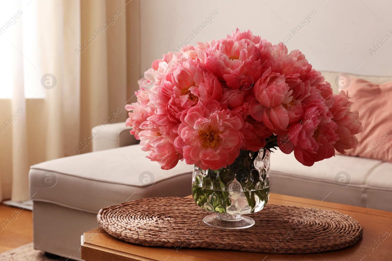 Photo of Beautiful pink peonies in vase on table at home, space for text. Interior design