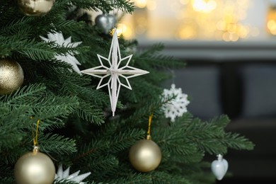 Closeup of different beautiful baubles hanging on Christmas tree. Space for text