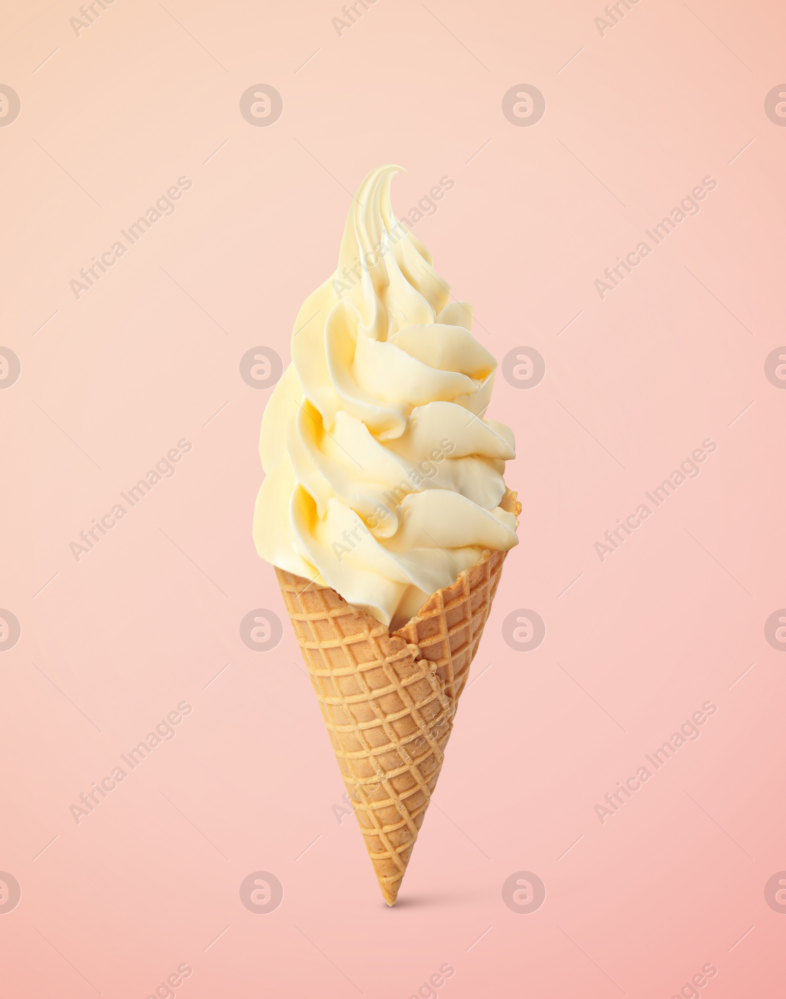 Image of Delicious soft serve vanilla ice cream in crispy cone on pastel pink background