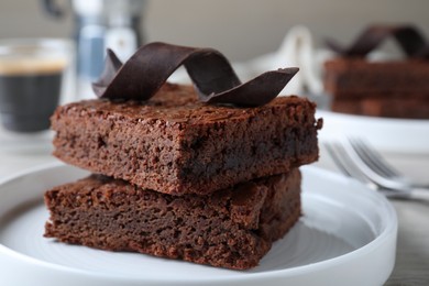 Photo of Delicious chocolate brownies on table, closeup. Tasty dessert