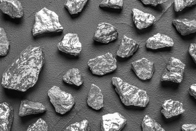 Photo of Many silver nuggets on grey table, flat lay