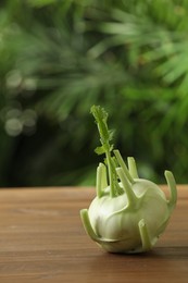 Photo of Whole ripe kohlrabi plant on wooden table