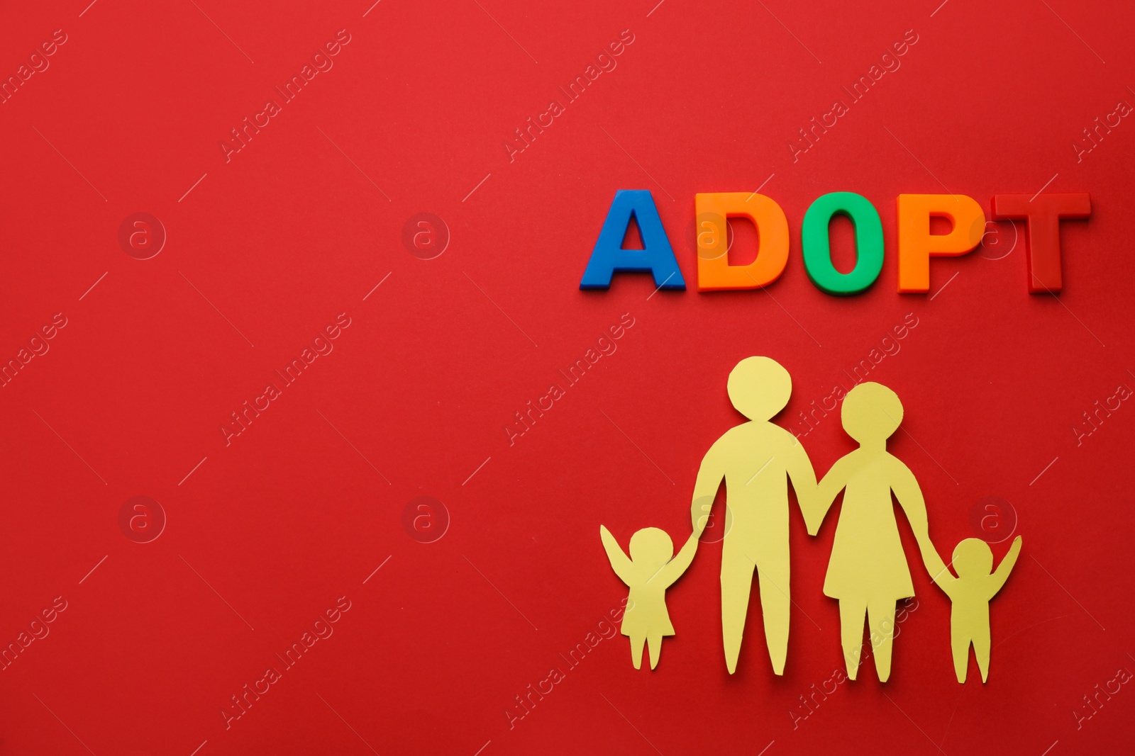 Photo of Family figure and word Adopt on red background, flat lay. Space for text