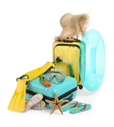 Photo of Suitcases and different beach accessories isolated on white. Summer vacation
