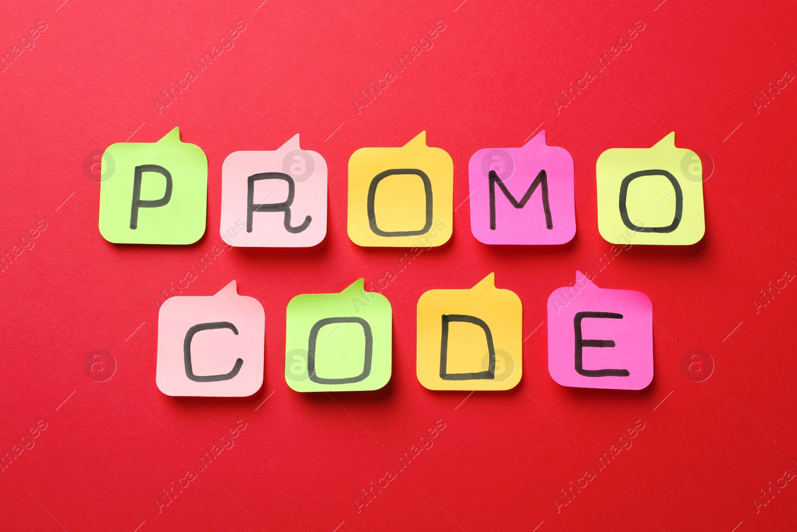 Photo of Sticky notes with words Promo Code on red background, flat lay