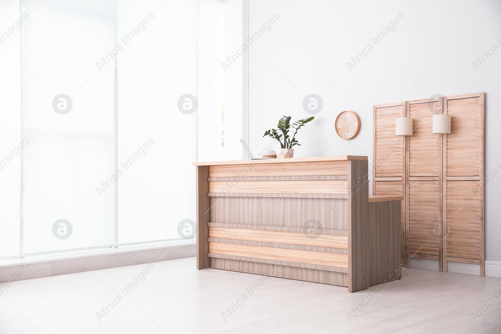 Photo of Hotel lobby interior with wooden reception desk