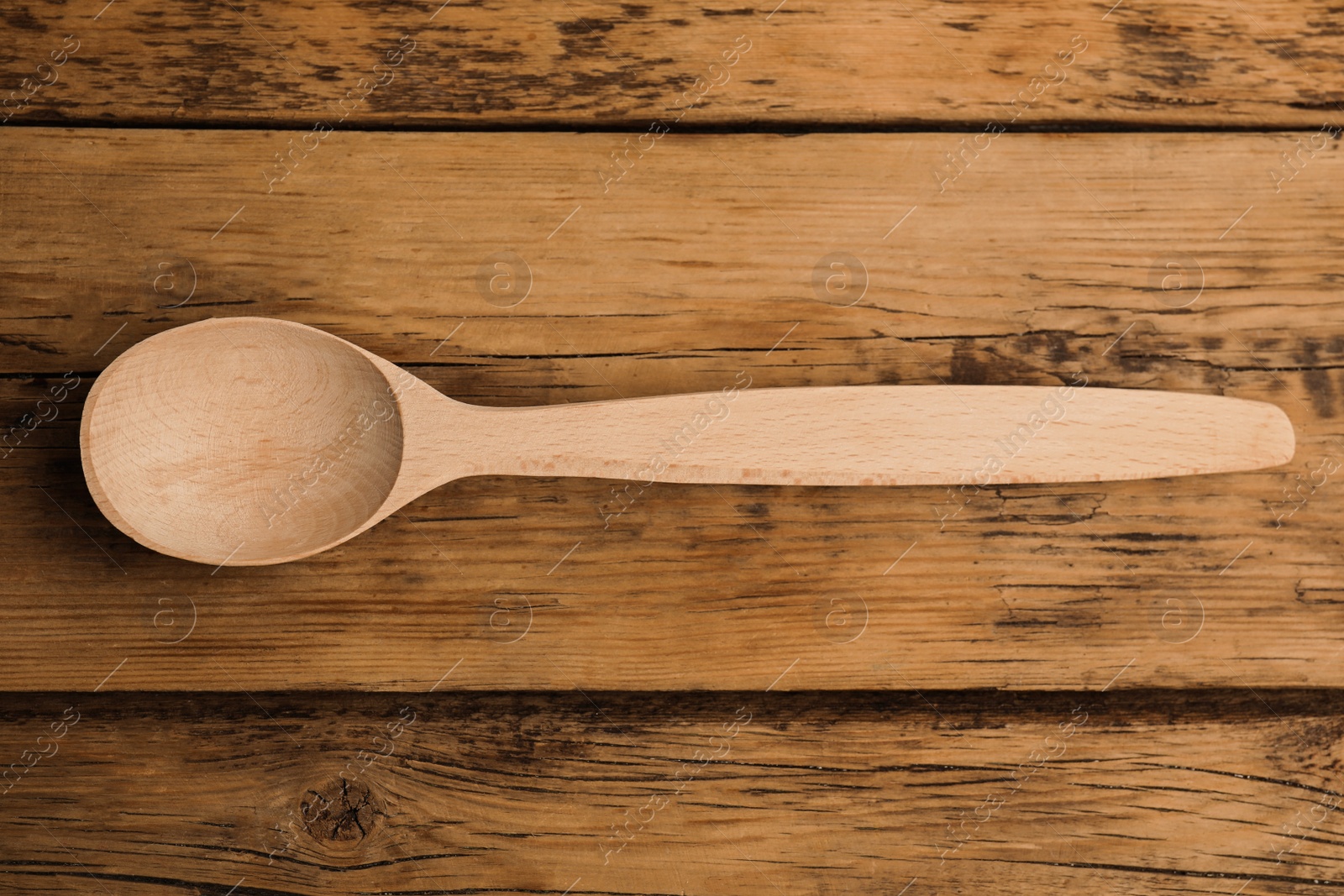 Photo of Handmade wooden spoon on rustic table, top view