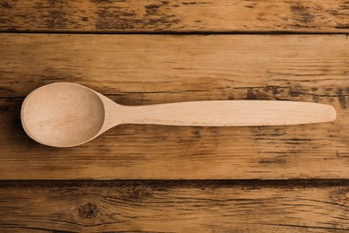 Photo of Handmade wooden spoon on rustic table, top view