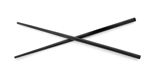 Photo of Pair of black chopsticks isolated on white, top view