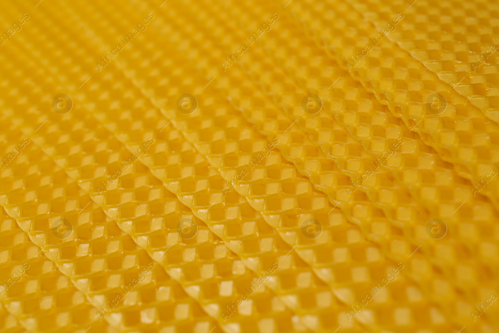 Photo of Natural organic beeswax sheet as background, closeup