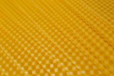 Photo of Natural organic beeswax sheet as background, closeup