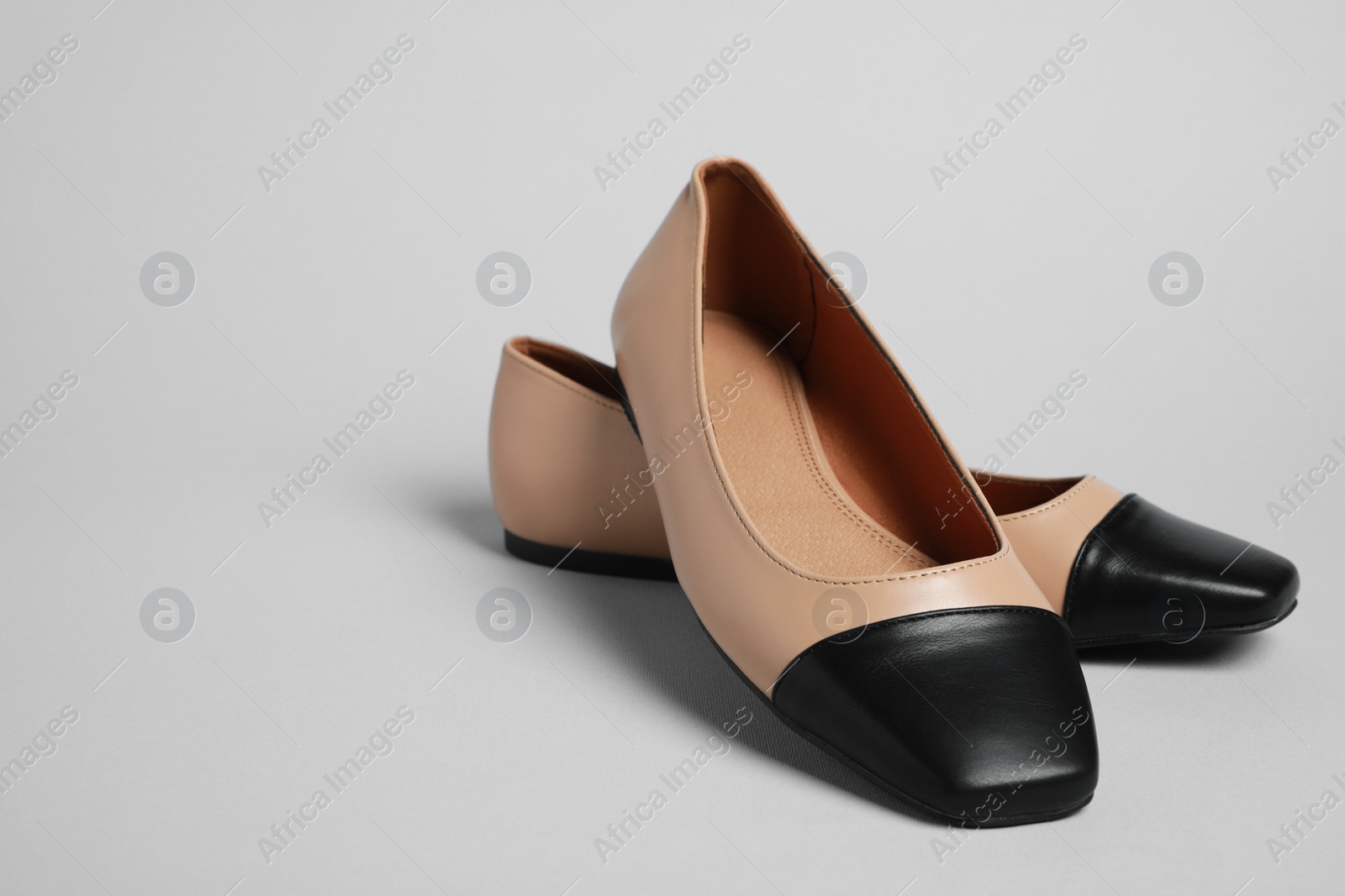 Photo of Pair of new stylish square toe ballet flats on light grey background