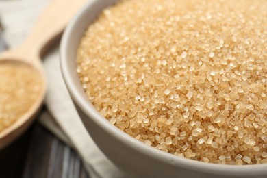 Photo of Brown sugar in bowl on table, closeup