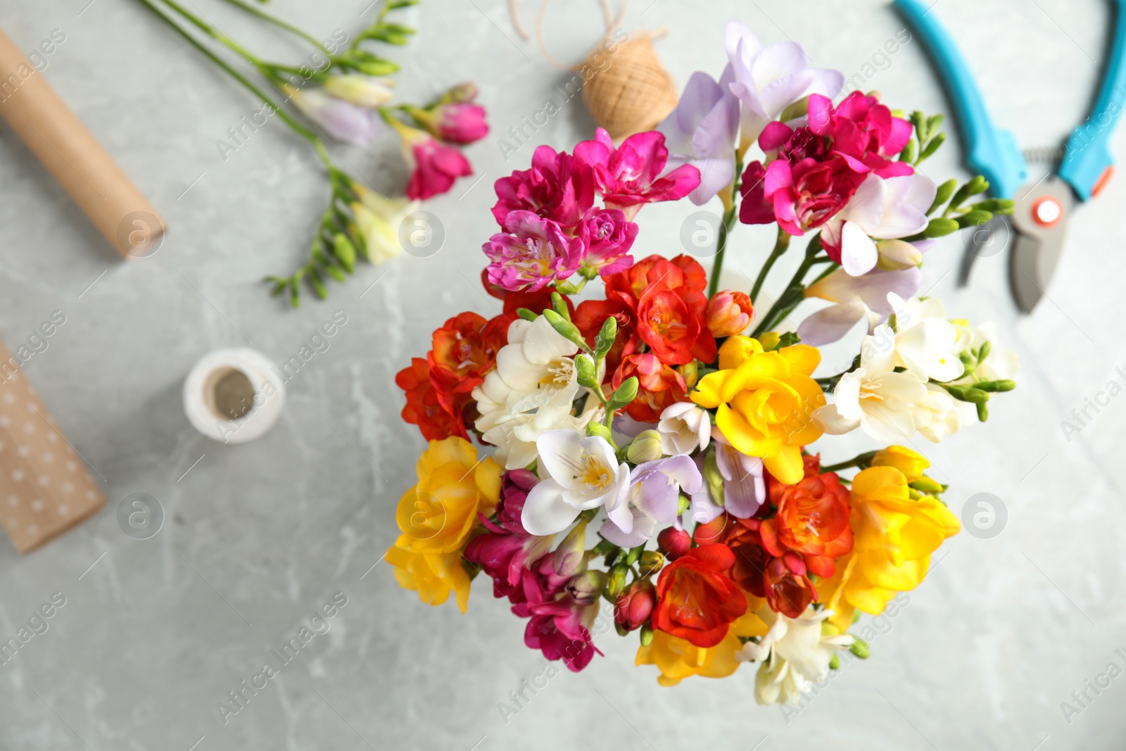 Photo of Flat lay composition with freesia bouquet on table