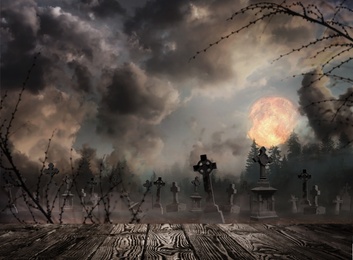 Image of Wooden surface and misty graveyard with old creepy headstones under full moon on Halloween