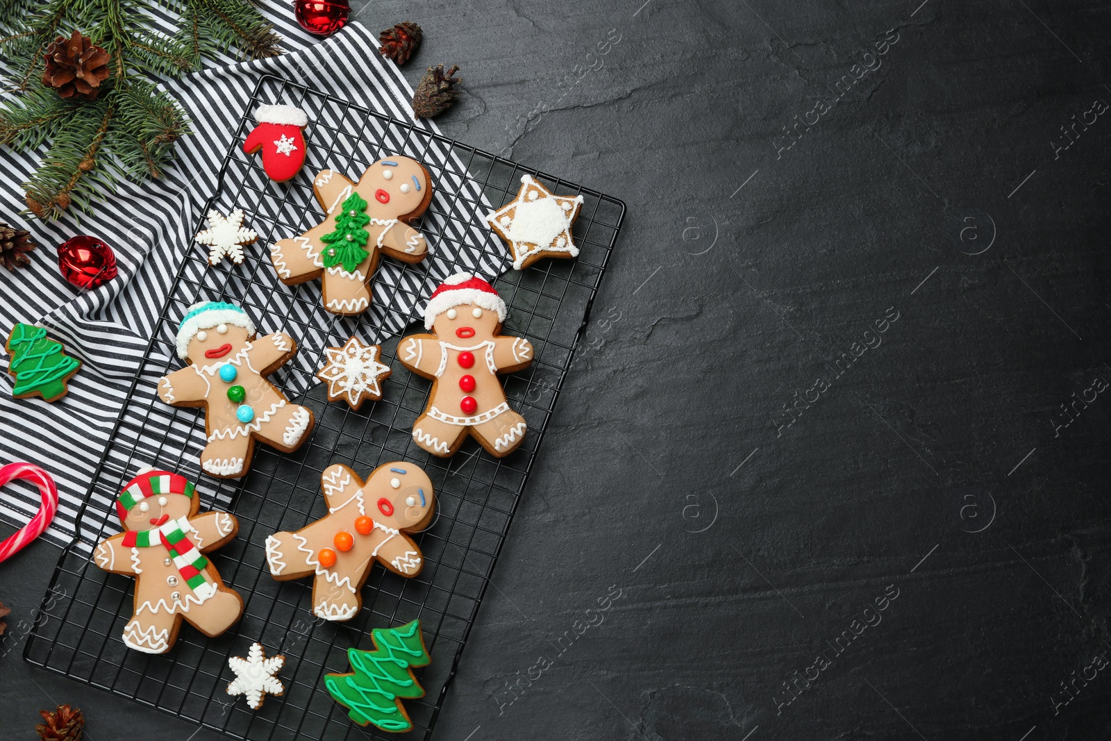 Photo of Flat lay composition with delicious Christmas cookies on black table, space for text