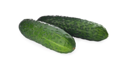 Photo of Whole fresh green cucumbers on white background