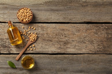 Flat lay composition with soybean oil on wooden table. Space for text