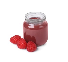 Jar of healthy baby food and fresh raspberries on white background