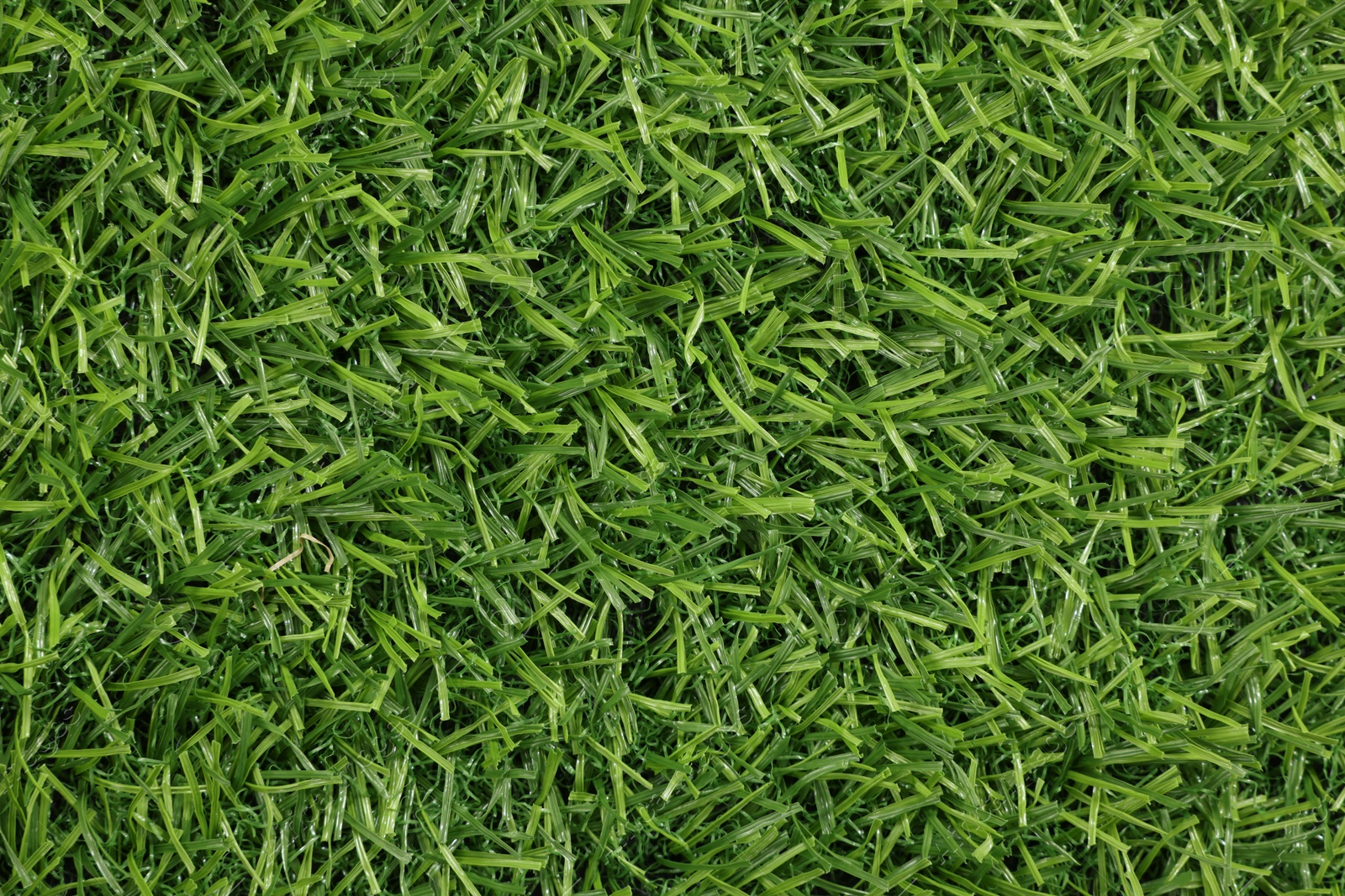 Photo of Green artificial grass as background, top view