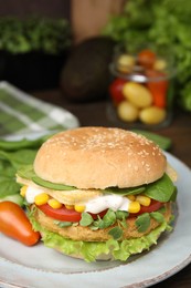 Photo of Tasty vegan burger with vegetables, patty and microgreens on table, closeup