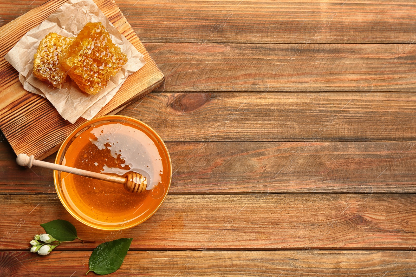 Photo of Fresh honey on wooden table, flat lay. Space for text