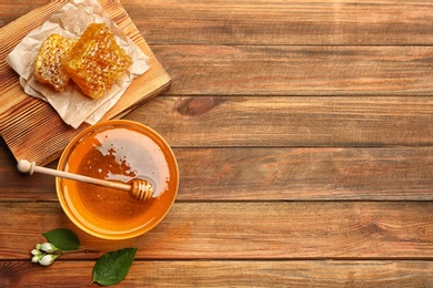 Photo of Fresh honey on wooden table, flat lay. Space for text