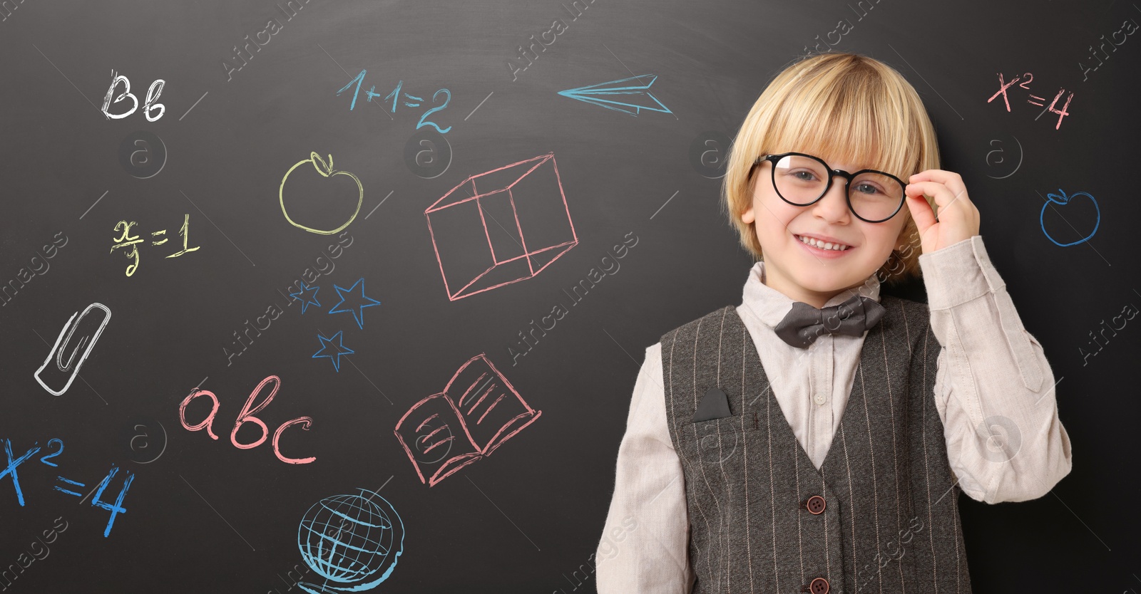 Image of School boy near blackboard with chalk drawings and inscriptions, banner design