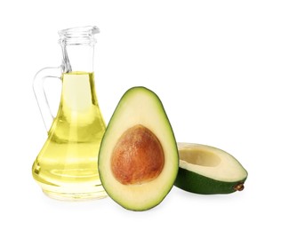 Photo of Cooking oil and fresh avocado halves isolated on white