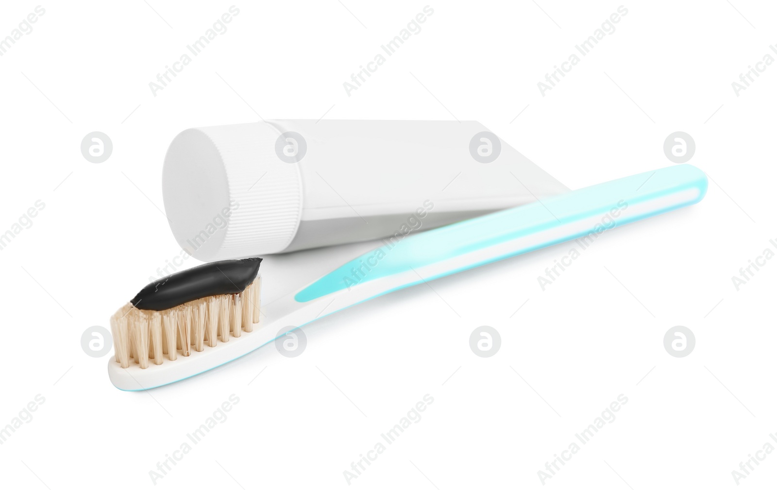 Photo of Natural bristle toothbrush with charcoal paste isolated on white