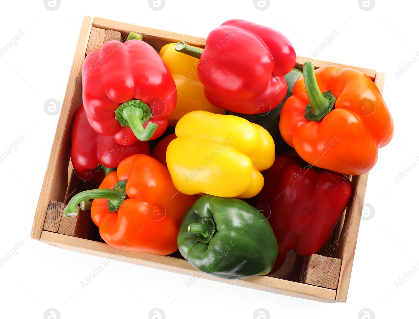 Photo of Wooden crate full of fresh ripe colorful bell peppers isolated on white, top view
