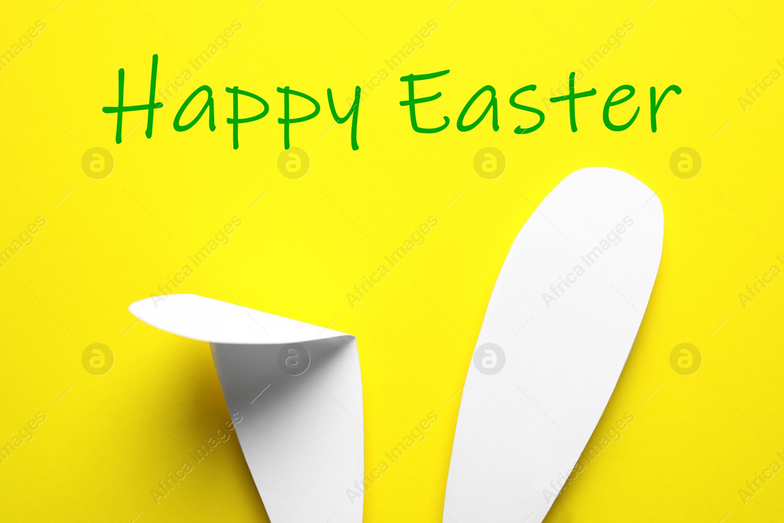 Image of Paper bunny ears on yellow background, top view. Happy Easter 