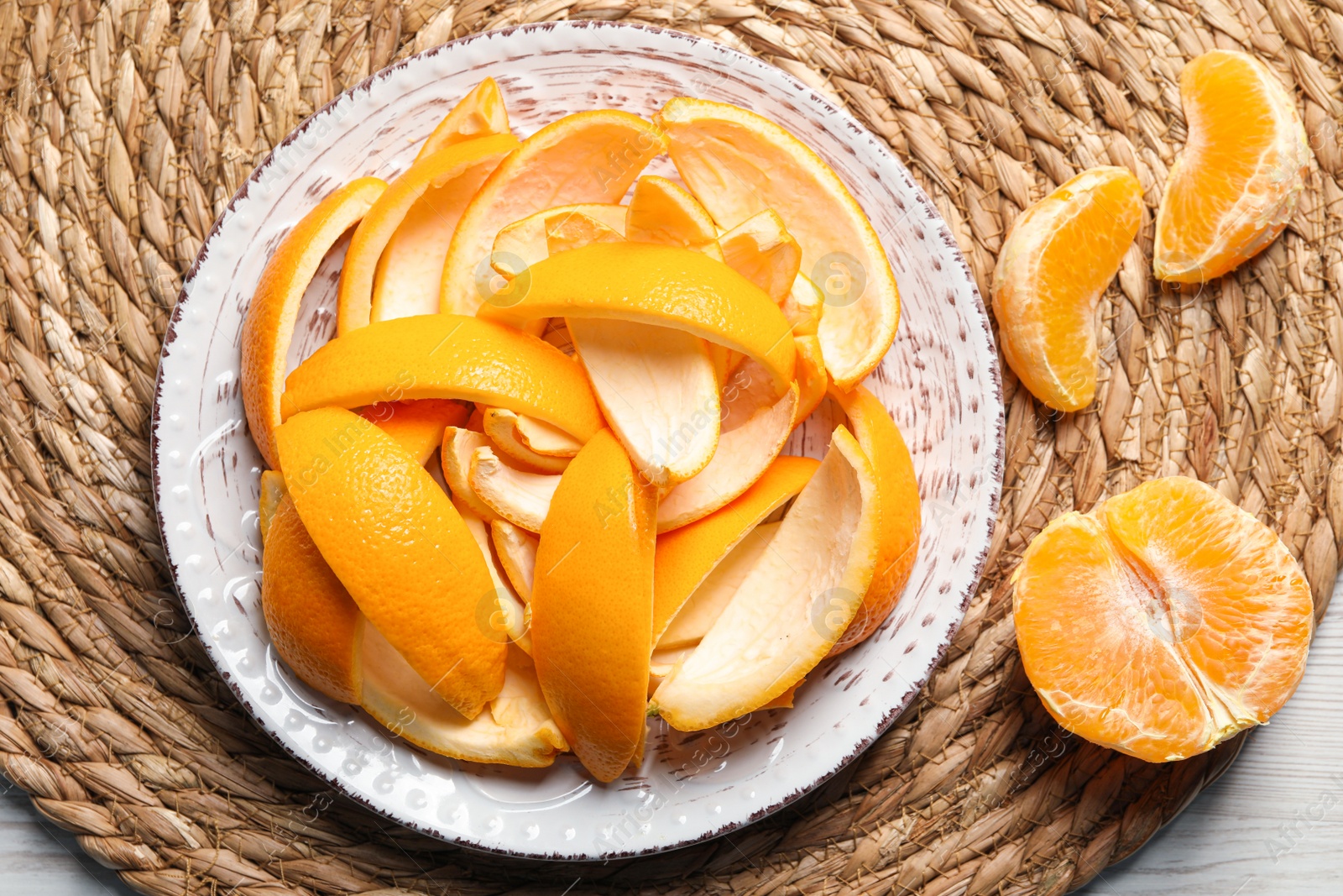 Photo of Orange peels preparing for drying and fresh fruit on white wooden table, top view