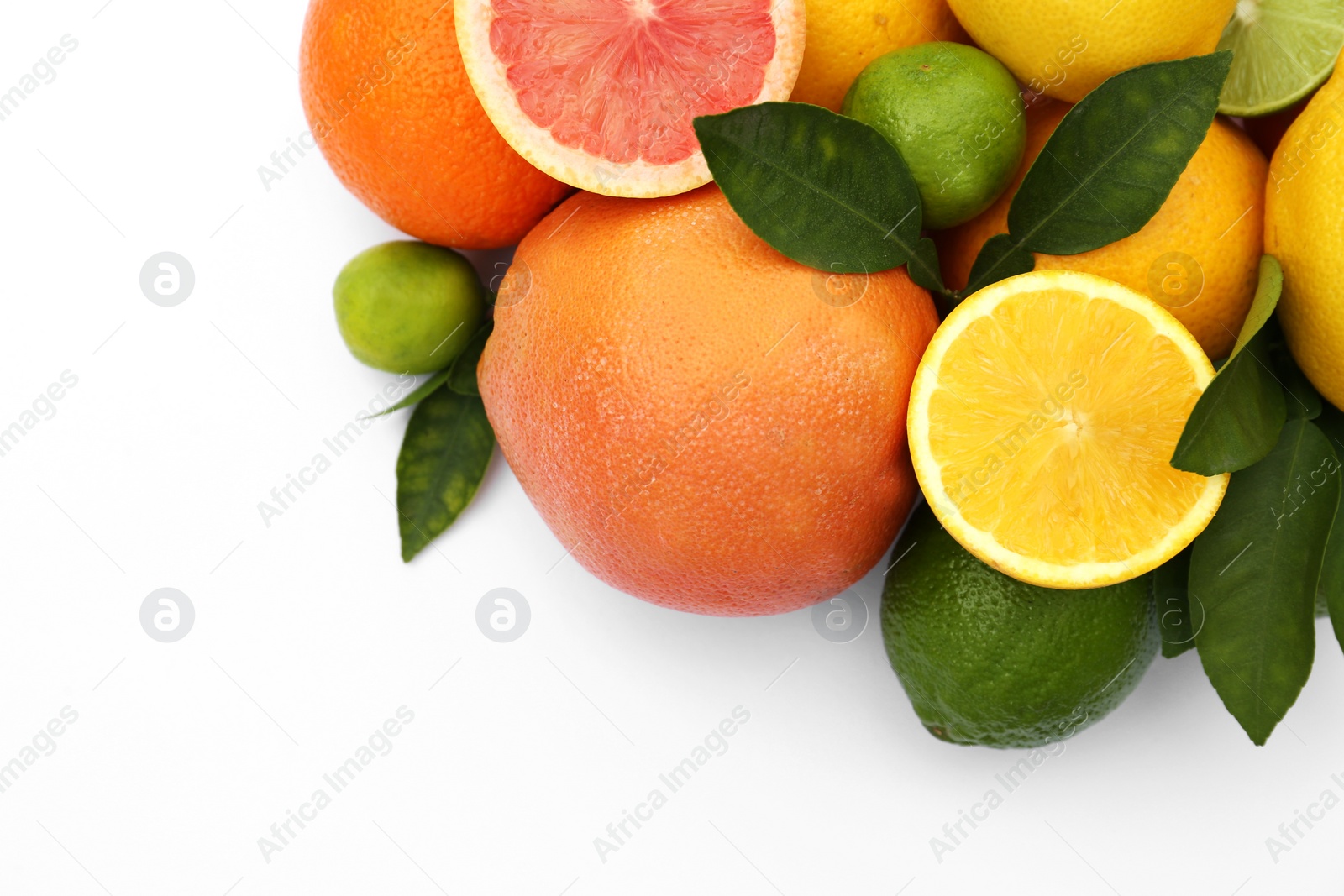 Photo of Different citrus fruits and leaves on white background, top view. Space for text