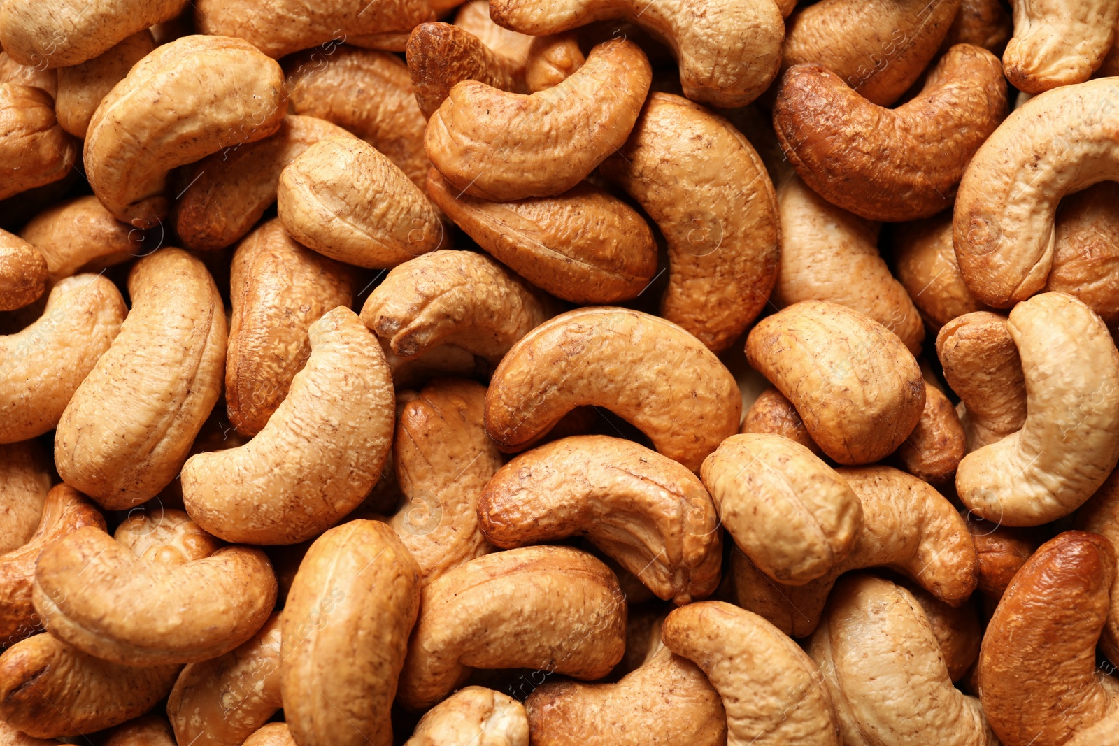 Photo of Tasty cashew nuts as background, top view