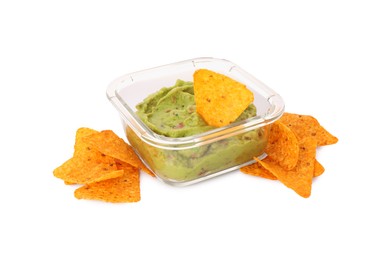 Photo of Bowl of delicious guacamole with nachos chips isolated on white