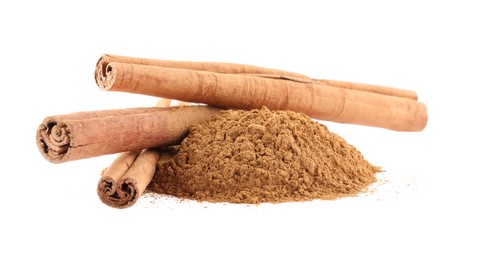 Photo of Dry aromatic cinnamon sticks and powder isolated on white