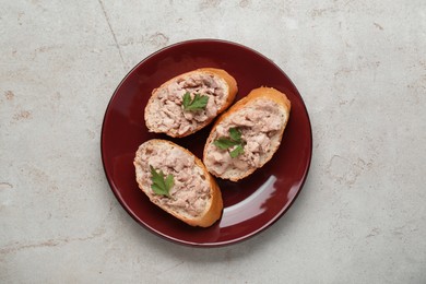 Photo of Tasty sandwiches with cod liver on light grey table, top view