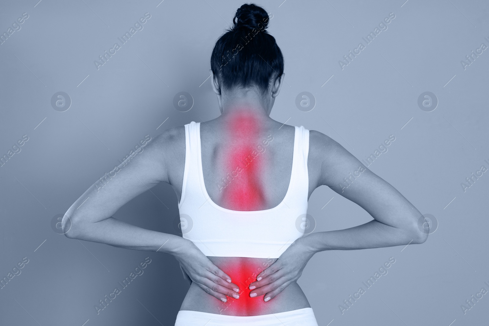 Image of Woman suffering from back pain on color background