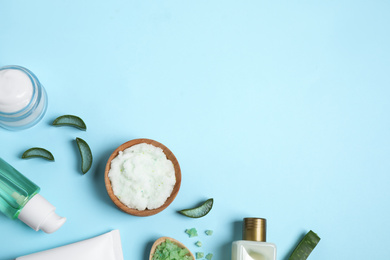 Photo of Flat lay composition with aloe vera and cosmetic products on light blue background. Space for text