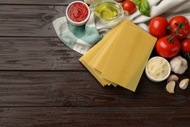 Photo of Ingredients for lasagna on wooden table, flat lay. Space for text