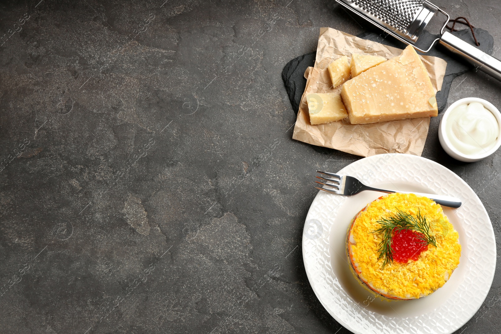 Photo of Flat lay composition with traditional russian salad Mimosa on grey table, space for text