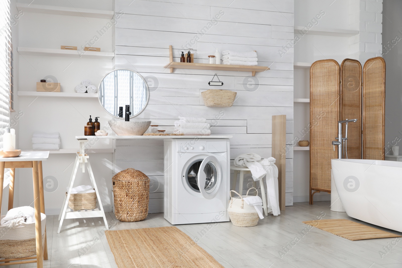 Photo of Stylish bathroom interior with modern washing machine