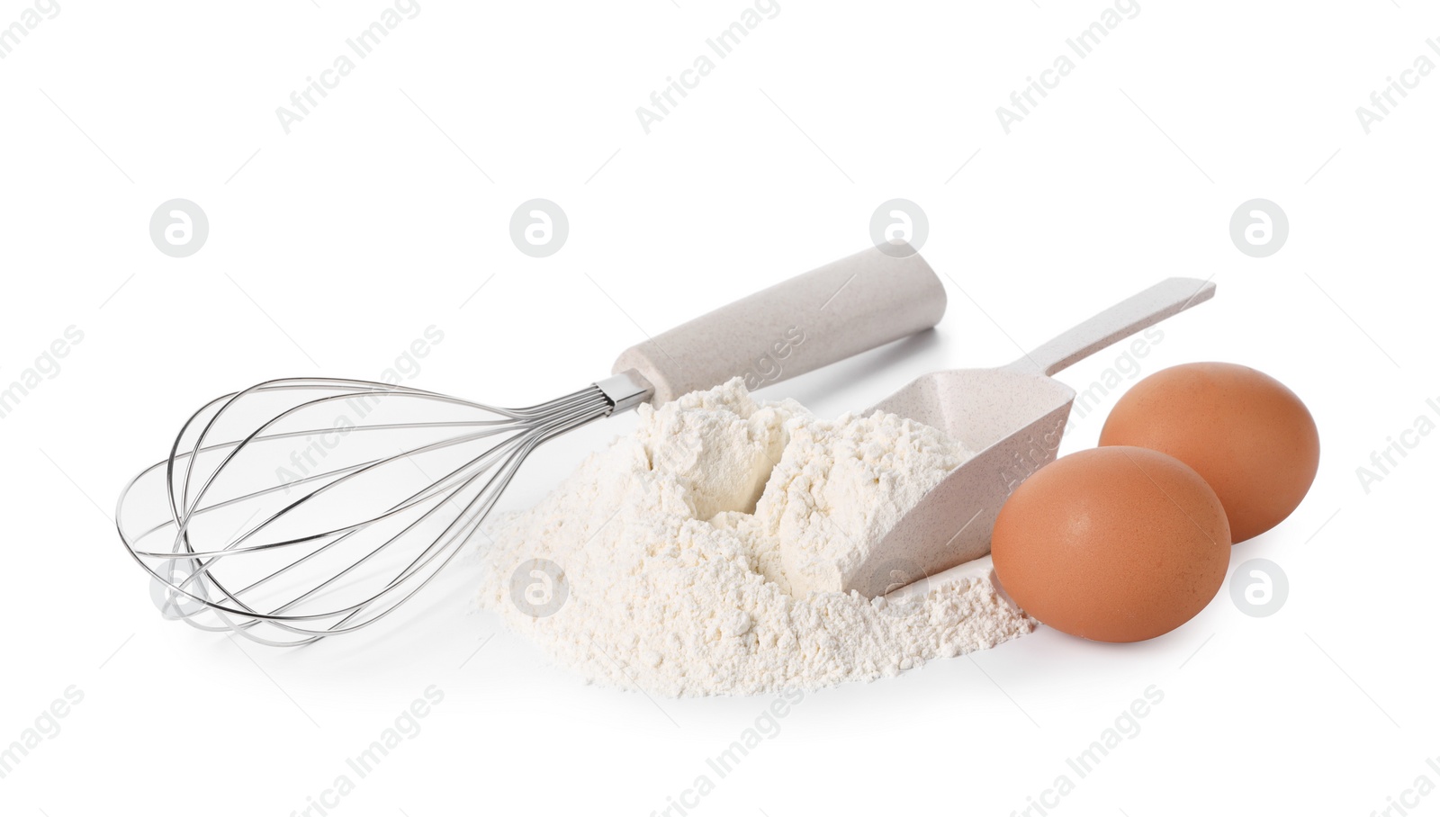 Photo of Whisk, raw eggs, flour and scoop isolated on white