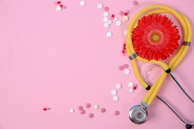 Photo of Flat lay composition with stethoscope, flower and pills on color background. Gynecological checkup