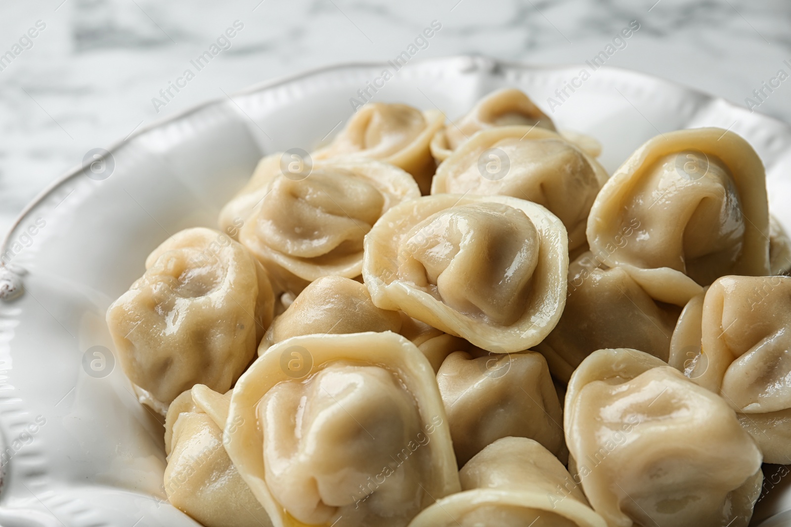 Photo of Tasty dumplings in ceramic plate, closeup view