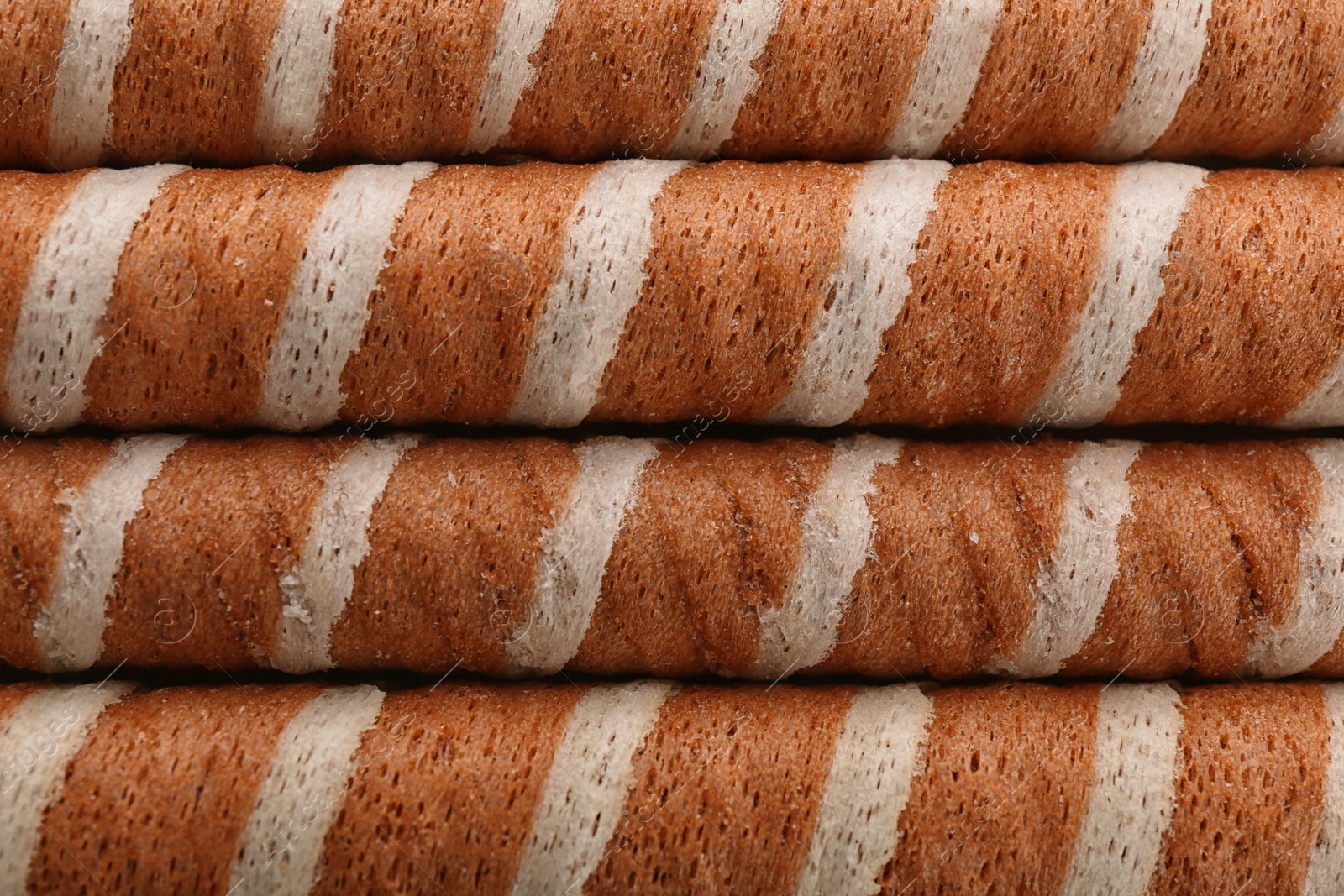 Photo of Tasty wafer roll sticks as background, top view. Crispy food