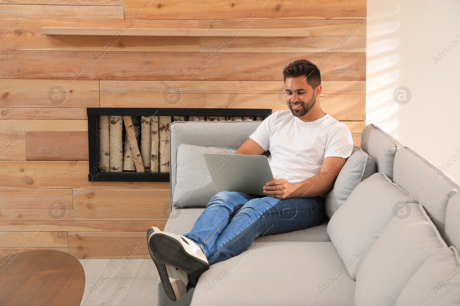 Photo of Man using laptop for online shopping at home