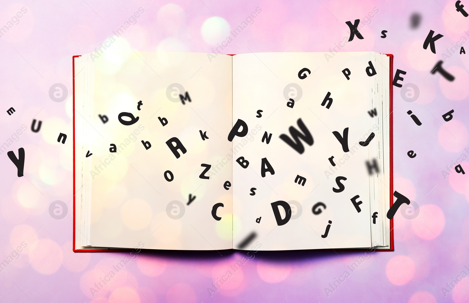 Image of Letters flying out from open book on lilac background, top view. Bokeh effect